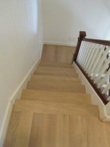 New installation of wide-board oak with a grayish stain.